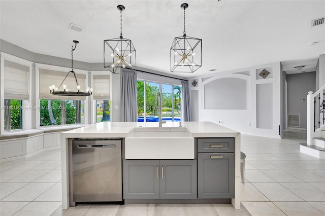 12339 NW 25th St, Coral Springs, FL 33065 - kitchen with stainless steel dishwasher, gray cabinetry, a chandelier, open floor plan, and light tile patterned floors