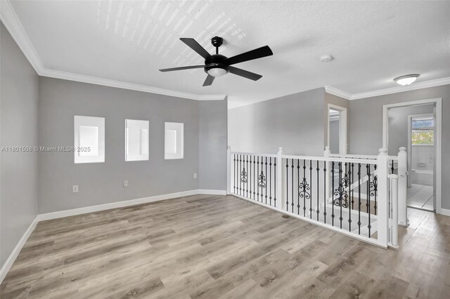 12339 NW 25th St, Coral Springs, FL 33065 - spare room featuring a ceiling fan, baseboards, wood finished floors, crown molding, and a smoke detector