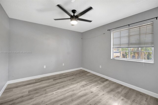 12339 NW 25th St, Coral Springs, FL 33065 - spare room featuring a ceiling fan, baseboards, and wood finished floors