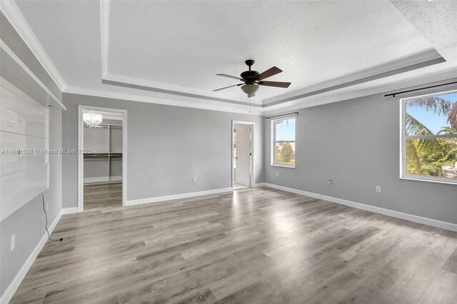 12339 NW 25th St, Coral Springs, FL 33065 - unfurnished bedroom featuring a raised ceiling, a textured ceiling, wood finished floors, crown molding, and baseboards