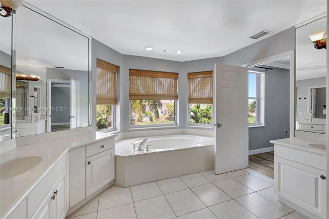 12339 NW 25th St, Coral Springs, FL 33065 - bathroom with two vanities, a garden tub, tile patterned flooring, and recessed lighting
