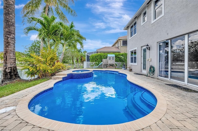 12339 NW 25th St, Coral Springs, FL 33065 - view of swimming pool featuring a fenced backyard and a pool with connected hot tub