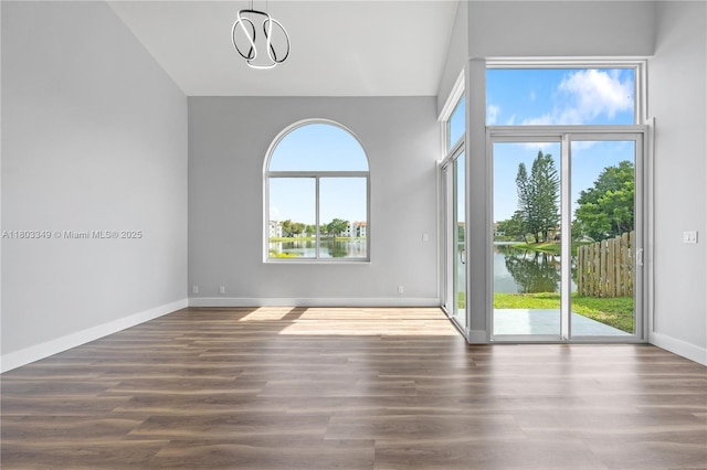 3835 Lombardy St, Hollywood, FL 33021 - unfurnished room with baseboards, a water view, wood finished floors, and a chandelier