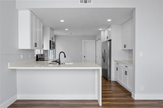3835 Lombardy St, Hollywood, FL 33021 - kitchen featuring appliances with stainless steel finishes, a sink, dark wood finished floors, a peninsula, and recessed lighting
