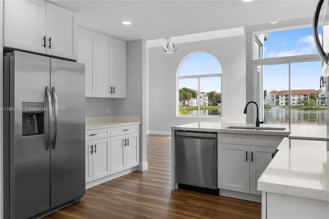 3835 Lombardy St, Hollywood, FL 33021 - kitchen featuring appliances with stainless steel finishes, a sink, dark wood-style floors, light stone counters, and recessed lighting