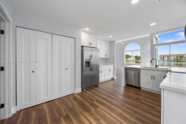 3835 Lombardy St, Hollywood, FL 33021 - kitchen featuring stainless steel appliances, dark wood-type flooring, a sink, recessed lighting, and white cabinetry
