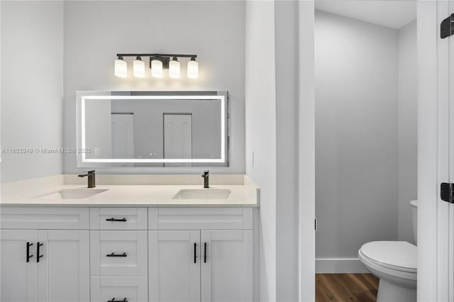 3835 Lombardy St, Hollywood, FL 33021 - full bath with toilet, double vanity, wood finished floors, and baseboards