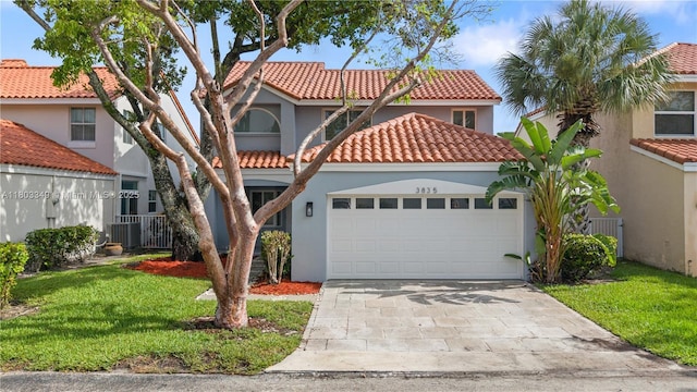 3835 Lombardy St, Hollywood, FL 33021 - mediterranean / spanish home featuring stucco siding, a tile roof, an attached garage, driveway, and central air condition unit