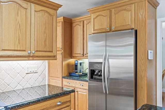 9750 SW 143rd Dr, Miami, FL 33176 - kitchen featuring stainless steel fridge with ice dispenser, dark stone countertops, and backsplash