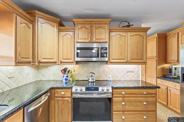 9750 SW 143rd Dr, Miami, FL 33176 - kitchen with stainless steel appliances, dark stone countertops, tasteful backsplash, and light tile patterned flooring