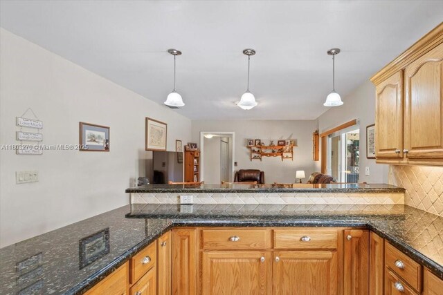 9750 SW 143rd Dr, Miami, FL 33176 - kitchen with backsplash, hanging light fixtures, dark stone counters, and open floor plan