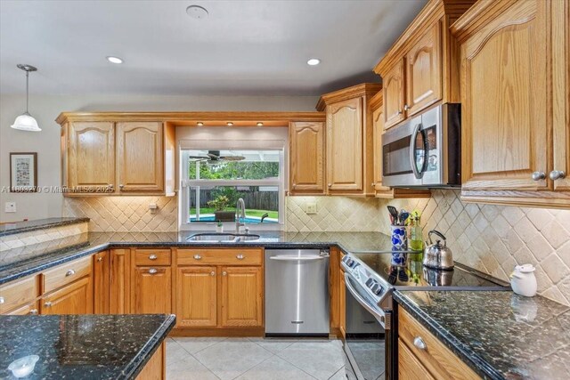 9750 SW 143rd Dr, Miami, FL 33176 - kitchen with appliances with stainless steel finishes, a sink, dark stone counters, and backsplash