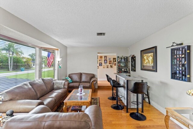 9750 SW 143rd Dr, Miami, FL 33176 - living area featuring wood finished floors, a textured ceiling, and baseboards