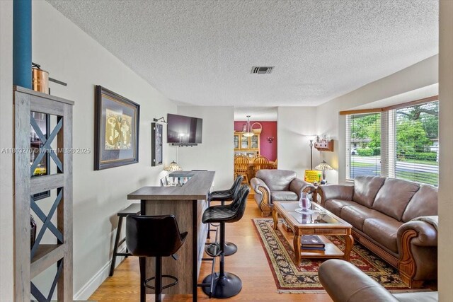 9750 SW 143rd Dr, Miami, FL 33176 - living room with a textured ceiling and light wood finished floors