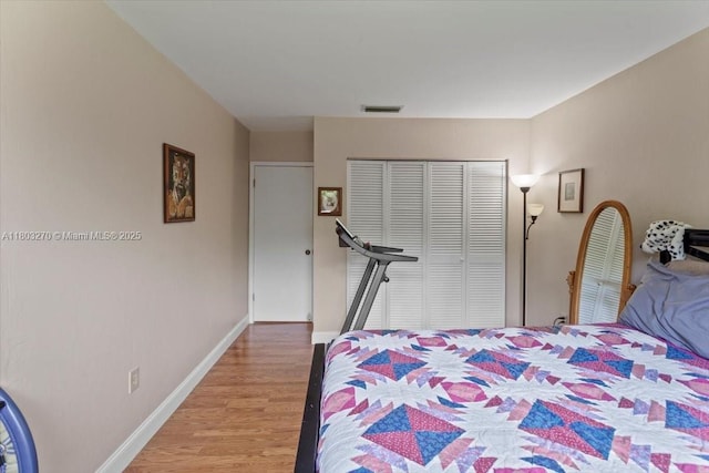 9750 SW 143rd Dr, Miami, FL 33176 - bedroom with light wood-type flooring, a closet, and baseboards