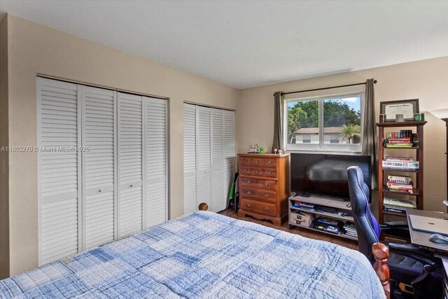 9750 SW 143rd Dr, Miami, FL 33176 - bedroom with two closets, a desk, and wood finished floors