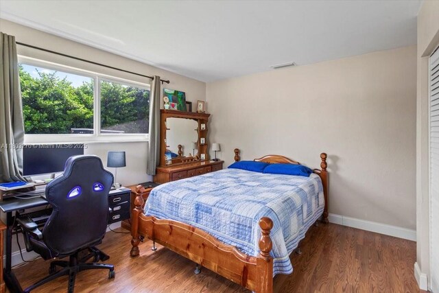 9750 SW 143rd Dr, Miami, FL 33176 - bedroom featuring wood finished floors, an office area, and baseboards