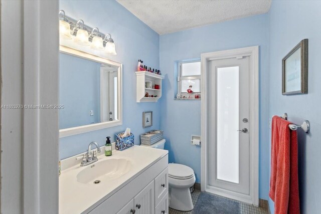 9750 SW 143rd Dr, Miami, FL 33176 - bathroom featuring a textured ceiling, vanity, and toilet