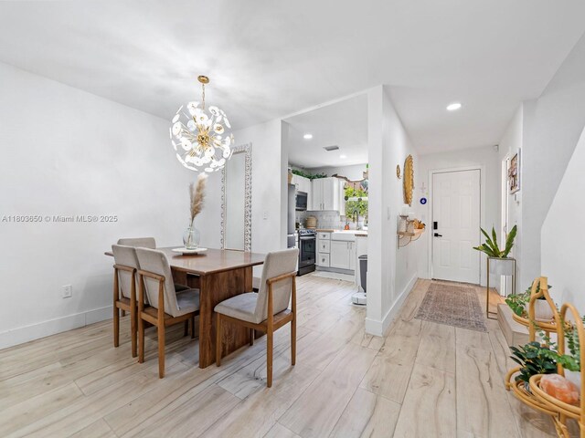 7165 W 13th Ave, Hialeah, FL 33014 - dining room featuring a chandelier, light wood-style flooring, baseboards, and recessed lighting