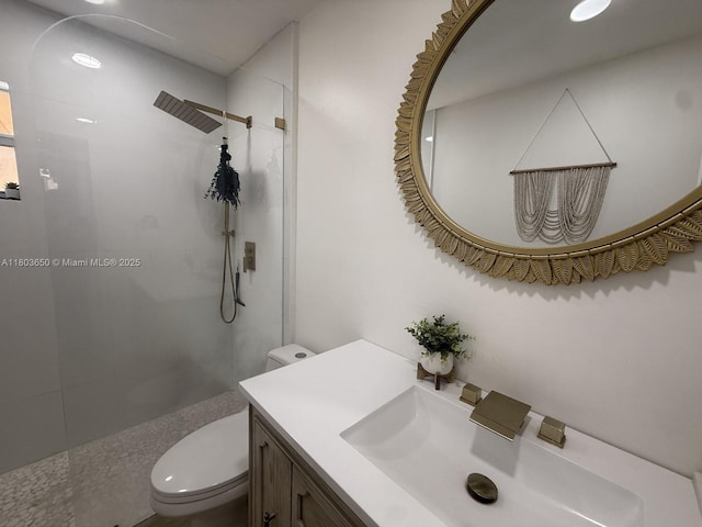 bathroom featuring toilet, walk in shower, and vanity