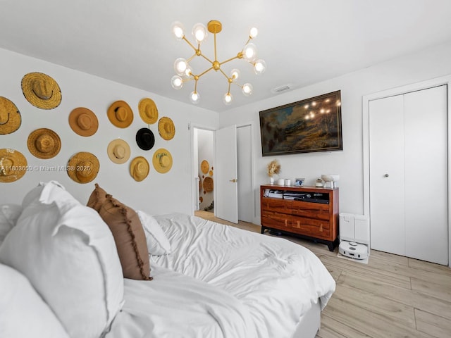 7165 W 13th Ave, Hialeah, FL 33014 - bedroom with light wood finished floors and a chandelier