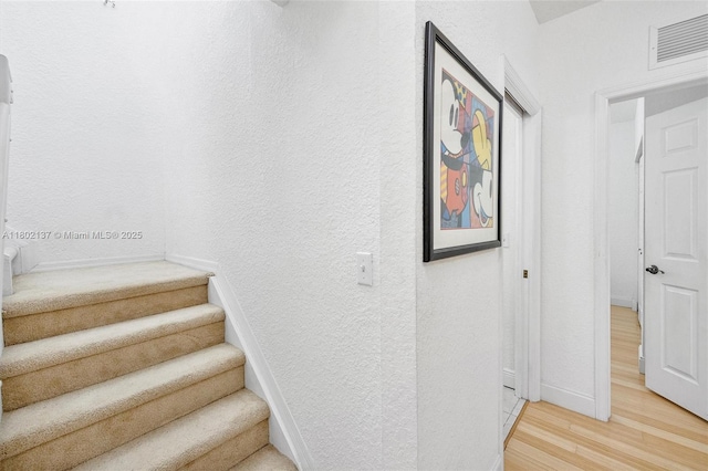 2350 SE 19th Ct Unit 0, Homestead, FL 33035 - stairway featuring wood finished floors, a textured wall, and baseboards