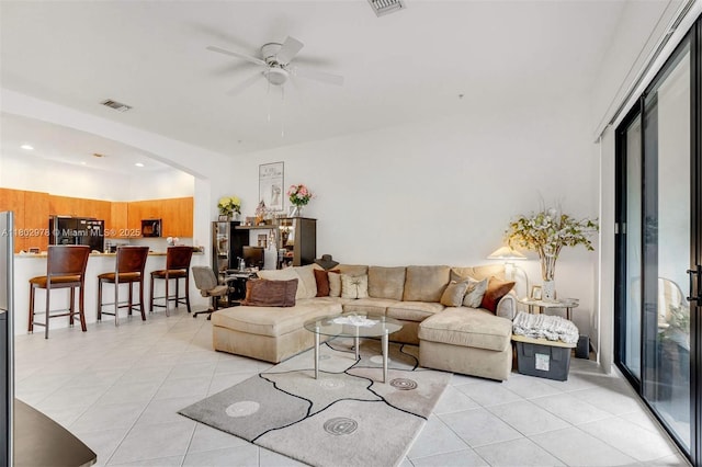 2901 NW 126th Ave Unit 2-415, Sunrise, FL 33323 - living room featuring light tile patterned floors, ceiling fan, and arched walkways