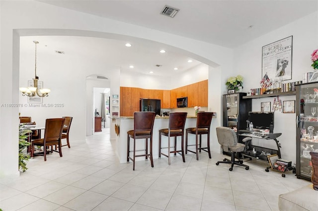 2901 NW 126th Ave Unit 2-415, Sunrise, FL 33323 - kitchen with arched walkways, black appliances, brown cabinets, a chandelier, and recessed lighting