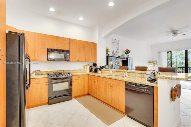2901 NW 126th Ave Unit 2-415, Sunrise, FL 33323 - kitchen featuring black appliances, a peninsula, arched walkways, a sink, and light stone counters