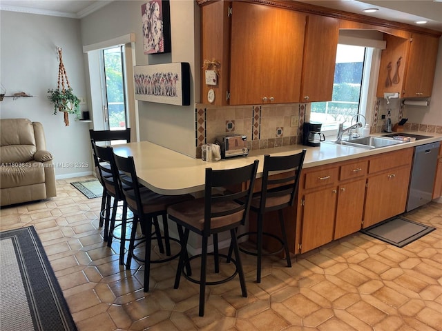 1101 SW 75th Ter, Plantation, FL 33317 - kitchen featuring stainless steel dishwasher, light countertops, crown molding, backsplash, and brown cabinets