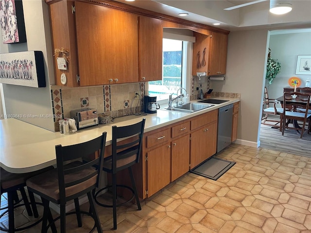 1101 SW 75th Ter, Plantation, FL 33317 - kitchen with stainless steel dishwasher, a sink, decorative backsplash, light countertops, and brown cabinetry