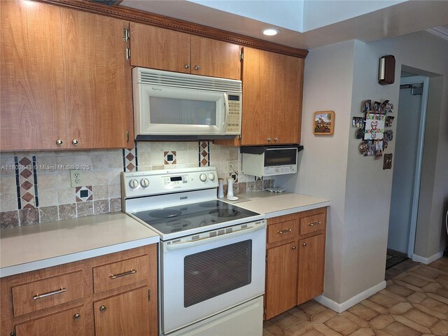 1101 SW 75th Ter, Plantation, FL 33317 - kitchen with white appliances, brown cabinets, tasteful backsplash, light countertops, and recessed lighting