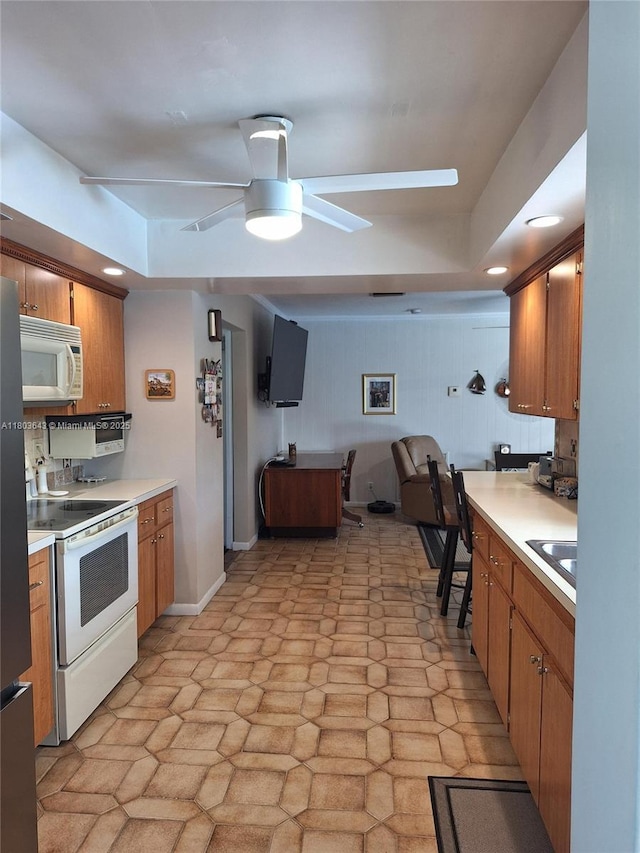 1101 SW 75th Ter, Plantation, FL 33317 - kitchen with white appliances, a ceiling fan, light countertops, and brown cabinets