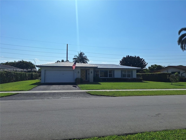 1101 SW 75th Ter, Plantation, FL 33317 - ranch-style house featuring a garage, asphalt driveway, and a front lawn