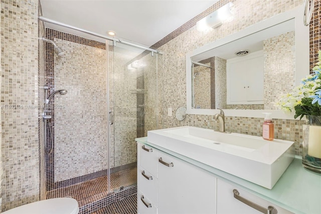 1 Harbour Way Unit 305, Bal Harbour, FL 33154 - full bathroom featuring tile walls, a stall shower, vanity, toilet, and tile patterned floors