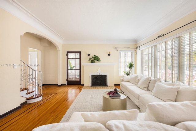 1801 SW 12th St, Miami, FL 33135 - living area with arched walkways, crown molding, wood finished floors, baseboards, and a fireplace