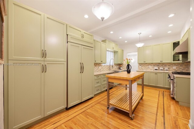 1801 SW 12th St, Miami, FL 33135 - kitchen featuring light wood-style floors, backsplash, hanging light fixtures, light countertops, and recessed lighting