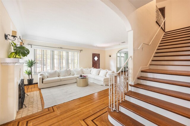 1801 SW 12th St, Miami, FL 33135 - living area featuring arched walkways, stairs, wood finished floors, and ornamental molding