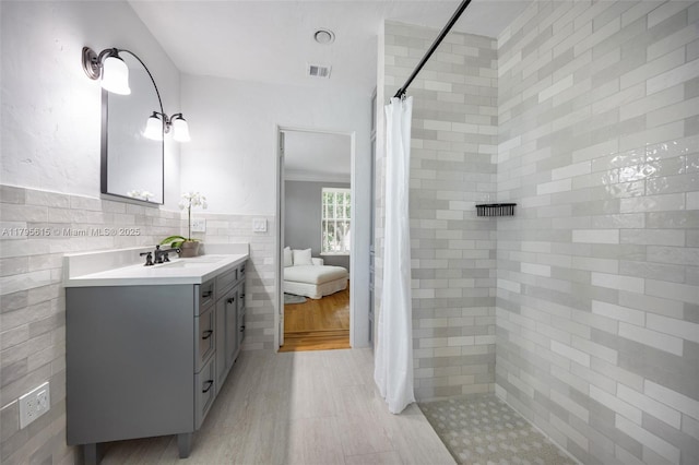 1801 SW 12th St, Miami, FL 33135 - bathroom with tile walls, tiled shower, and vanity
