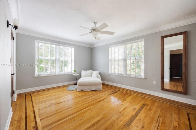 1801 SW 12th St, Miami, FL 33135 - sitting room with ornamental molding, healthy amount of natural light, wood finished floors, and baseboards