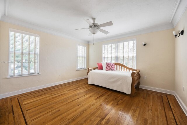 1801 SW 12th St, Miami, FL 33135 - bedroom featuring multiple windows, ornamental molding, baseboards, wood finished floors, and a ceiling fan