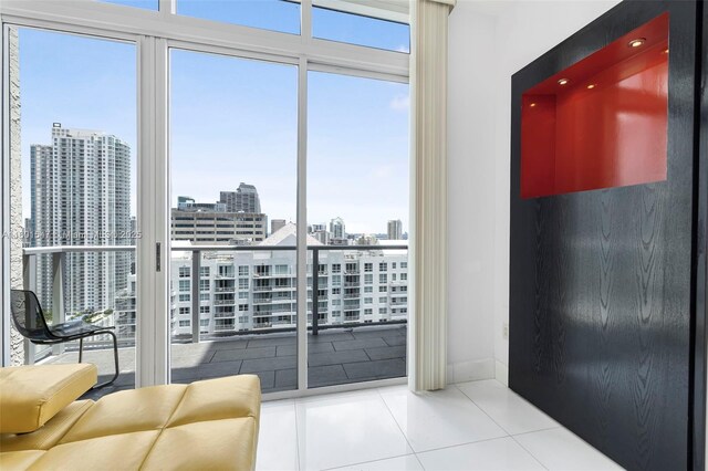 1155 Brickell Bay Dr Unit Ph204, Miami, FL 33131 - entryway with tile patterned flooring, a city view, and baseboards