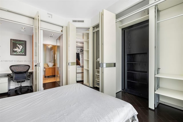1155 Brickell Bay Dr Unit Ph204, Miami, FL 33131 - bedroom with a desk, dark wood finished floors, and ensuite bathroom