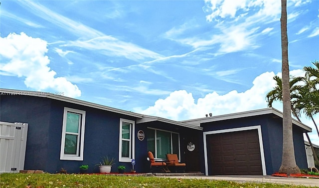 11400 NW 29th Mnr, Sunrise, FL 33323 - view of front of home with an attached garage, stucco siding, and a front lawn