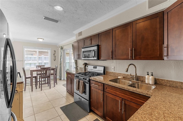 11400 NW 29th Mnr, Sunrise, FL 33323 - kitchen featuring appliances with stainless steel finishes, a sink, crown molding, a textured ceiling, and light stone countertops