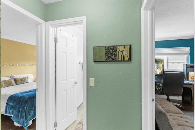 11400 NW 29th Mnr, Sunrise, FL 33323 - corridor with wood finished floors, crown molding, a desk, and a textured wall