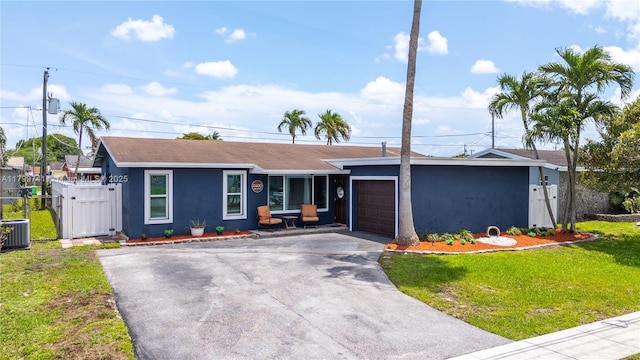 11400 NW 29th Mnr, Sunrise, FL 33323 - ranch-style home with asphalt driveway, an attached garage, stucco siding, central AC, and roof with shingles