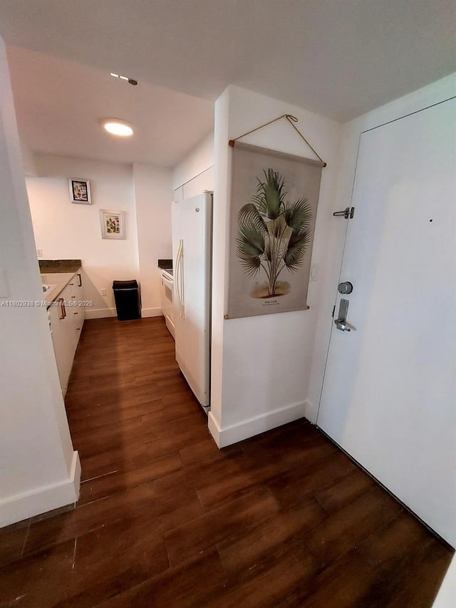 1200 Brickell Bay Dr Unit 3708, Miami, FL 33131 - hallway featuring dark wood-style flooring and baseboards