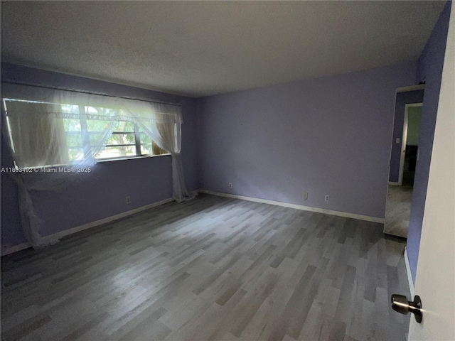 609 S State Road 7 Unit 2H, Margate, FL 33068 - empty room with wood finished floors and baseboards