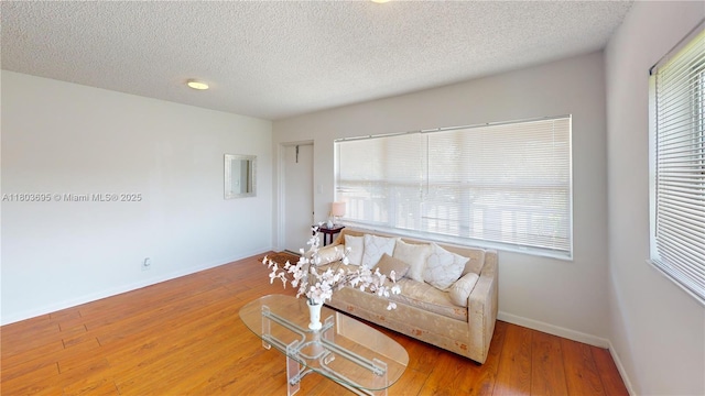 9121 Sunrise Lakes Blvd Unit 201, Sunrise, FL 33322 - living room featuring a textured ceiling, baseboards, and wood finished floors